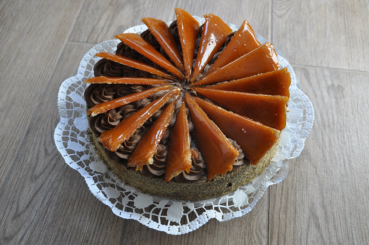 A slice of Dobos torta, a layered sponge cake with a caramel top