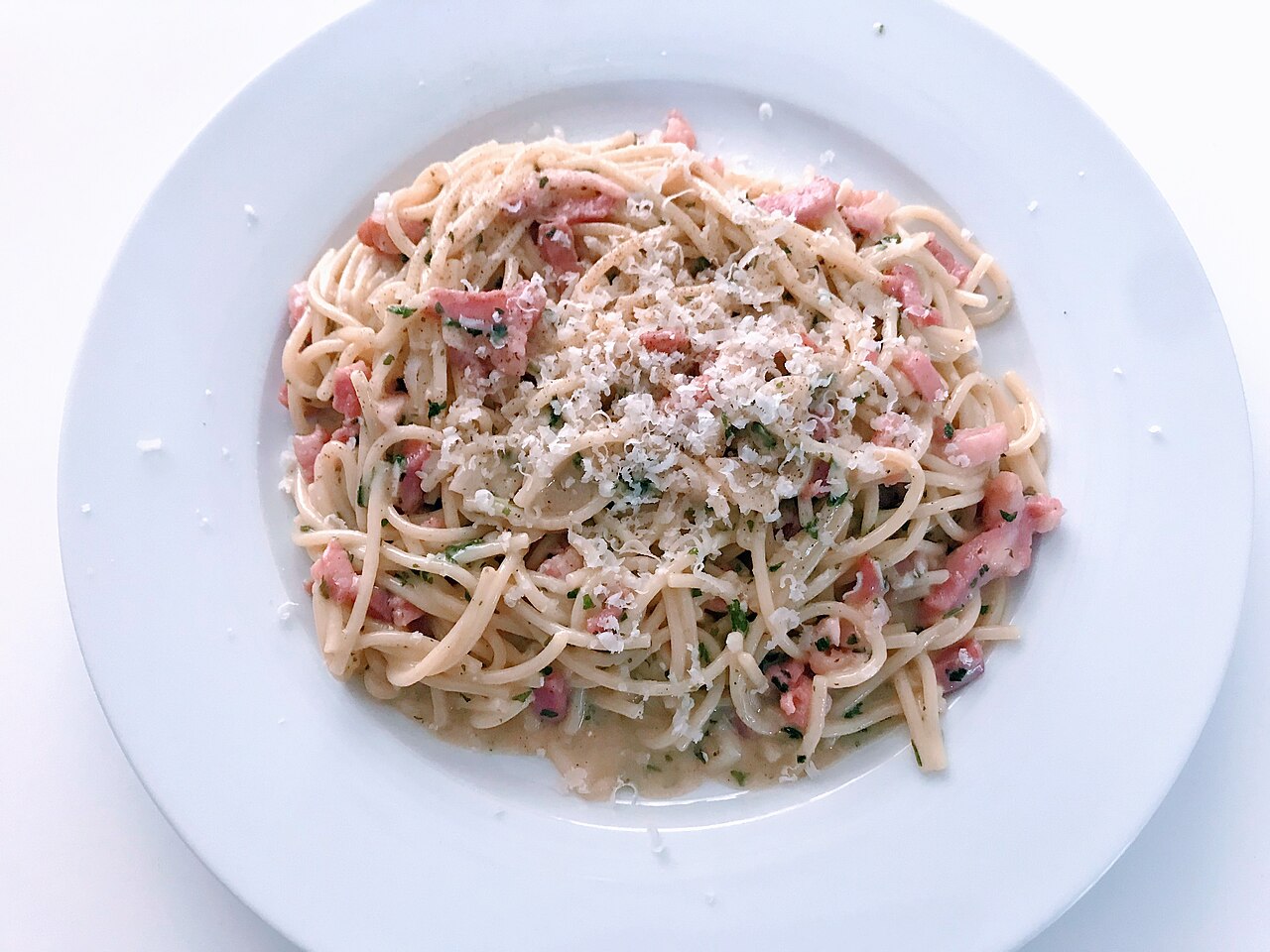 A plate of spaghetti alla carbonara with egg, cheese and pork