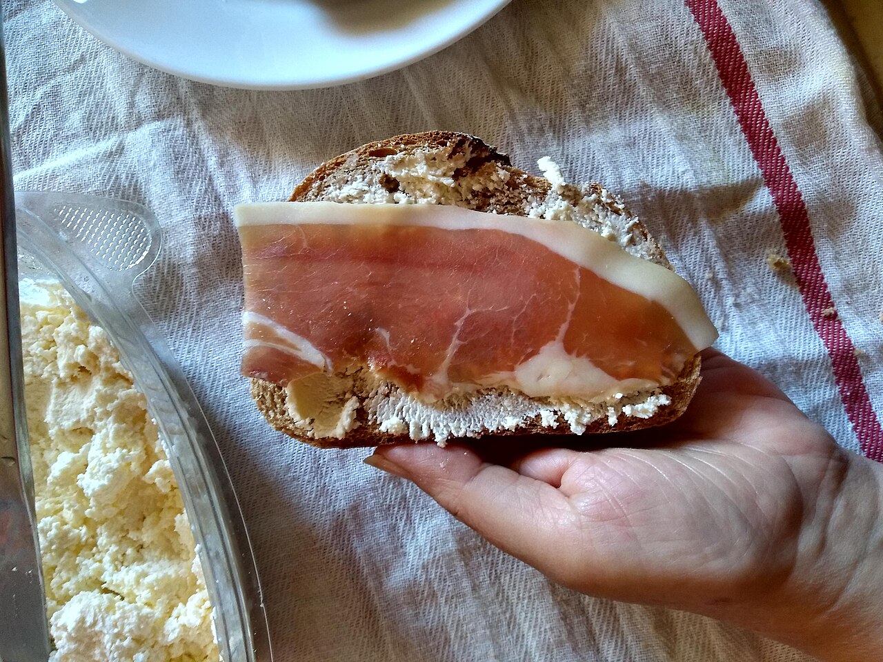 A plate of Montenegrin smoked ham, Njeguški pršut, with a dish of creamy kajmak