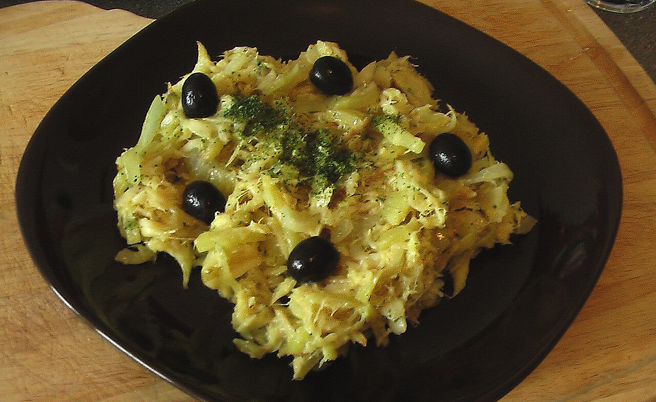 A plate of bacalhau à brás, shredded salt cod with egg and thin fried potato