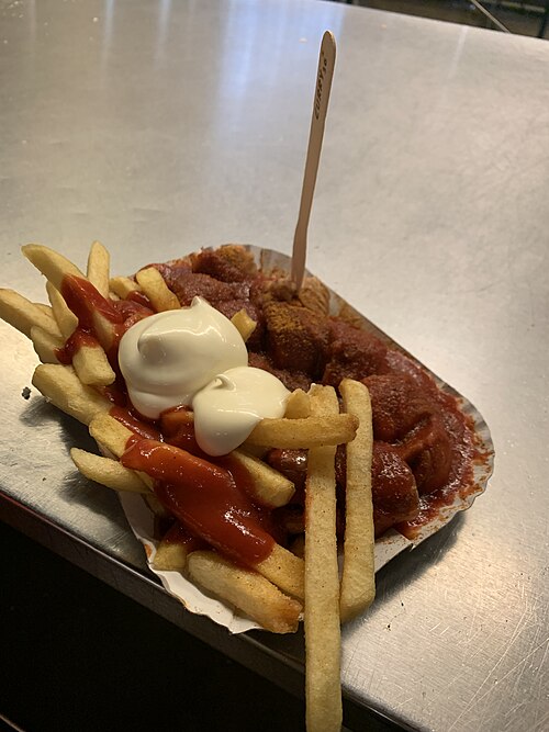 A currywurst from Curry 36 in Berlin, sliced sausage in curry sauce