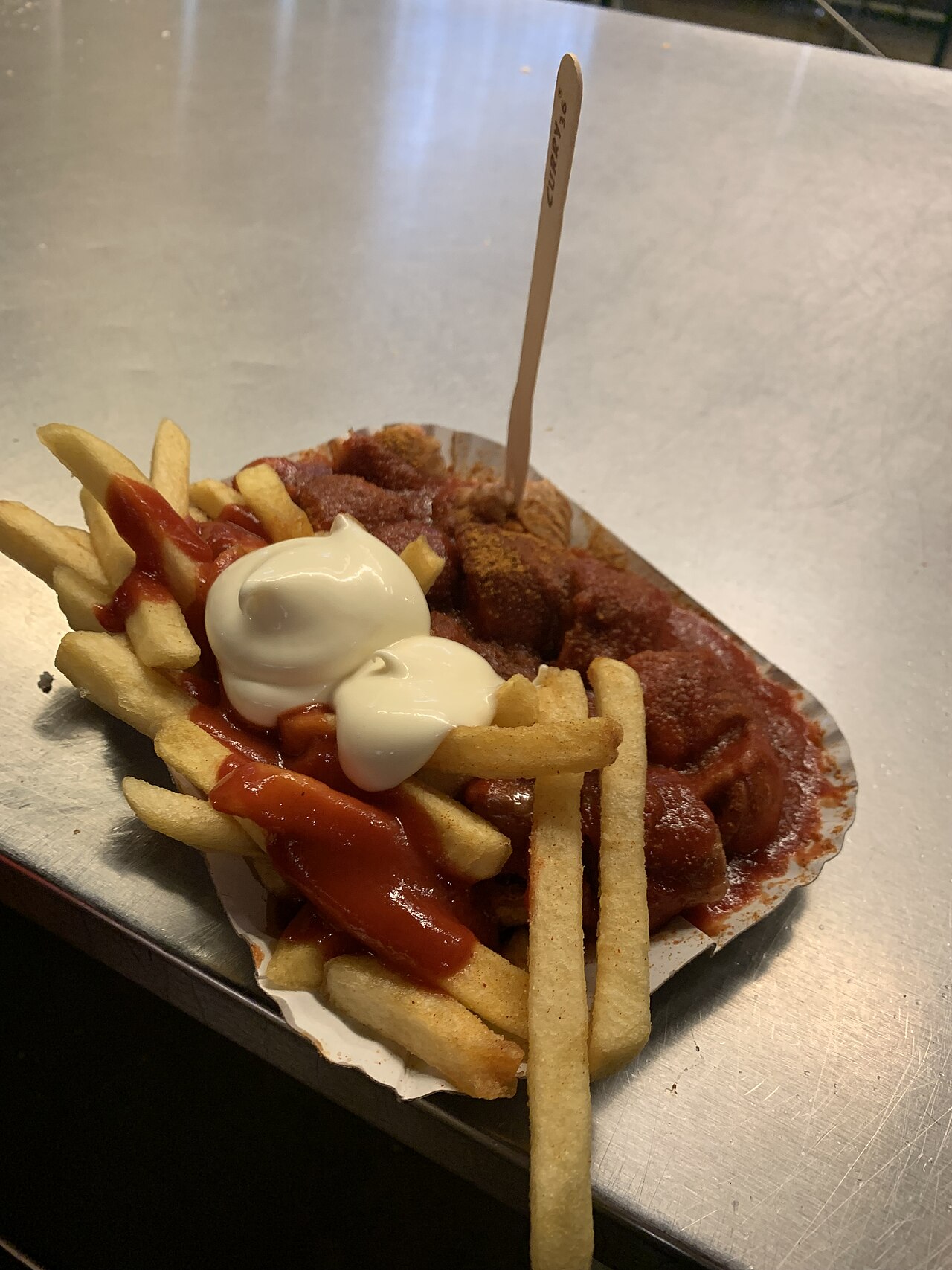 A currywurst from Curry 36 in Berlin, sliced sausage in curry sauce