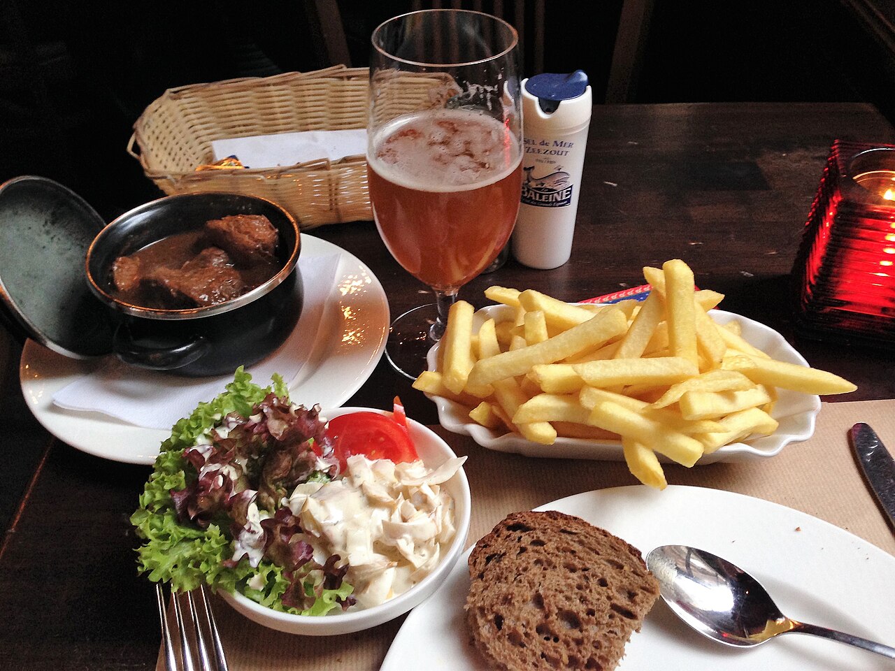 A plate of stoofvlees, Flemish beef stewed in beer, served with frites and a side salad