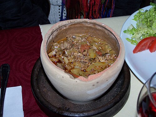 A testi kebab, the clay pot kebab of Göreme, served at a table
