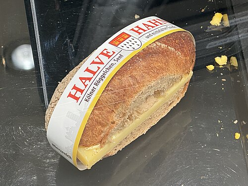 A rye roll filled with a slice of mature cheese, the Cologne snack called a Halve Hahn, in a bakery