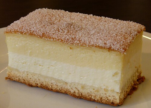 A slice of Dresdner Eierschecke, a layered cake with an egg custard top