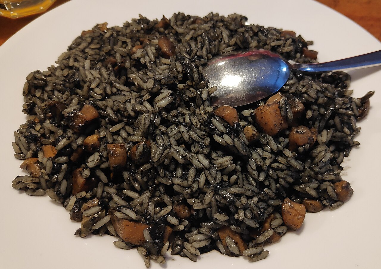 A plate of black risotto, made with cuttlefish ink