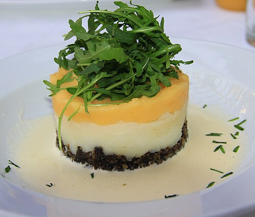 A plate of haggis with mashed turnip and potato