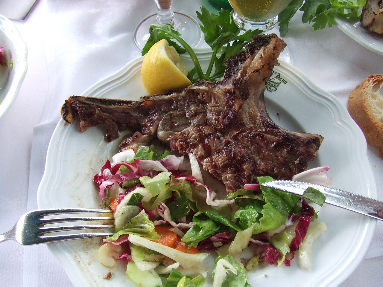 A thick grilled Florentine steak served on a board