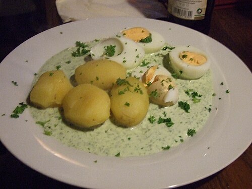 Boiled eggs and potatoes with Frankfurt green herb sauce on a plate