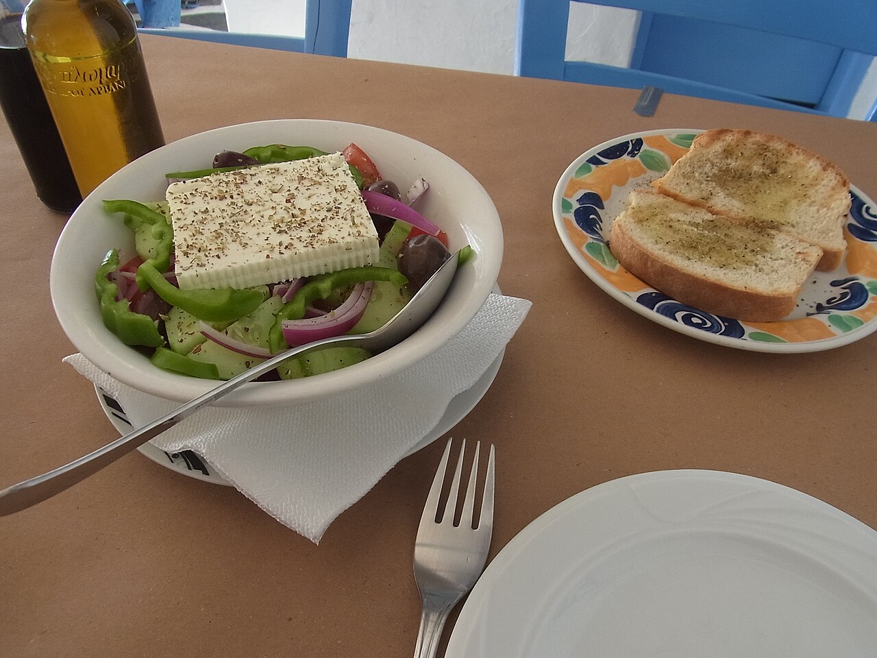 A Greek salad with tomato, cucumber, onion, olives and feta, served on Mykonos