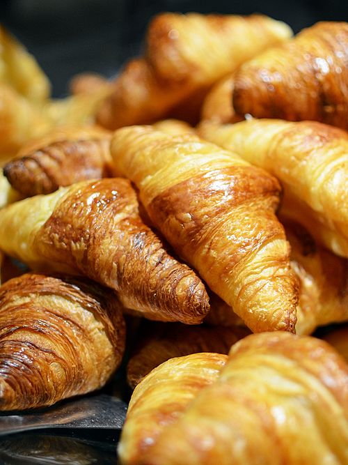 A tray of butter croissants in a Paris bakery