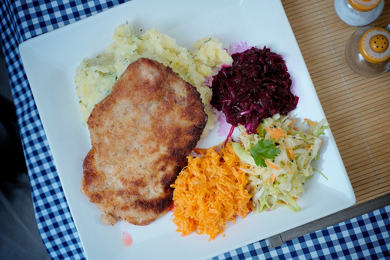 A breaded pork cutlet, kotlet schabowy, served on a plate